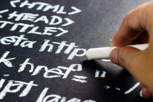 Writing code on a blackboard.