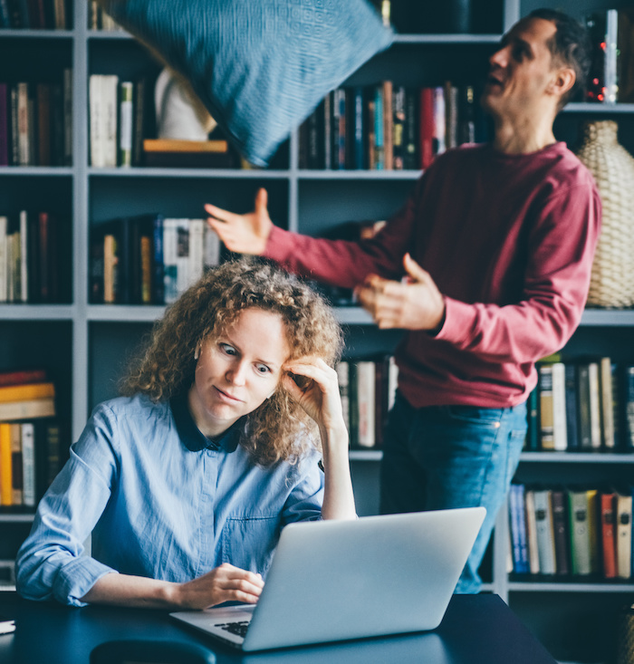 Woman works while man plays.