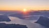 Sunrise over mountains and a lake.