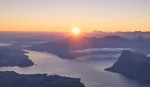 Sunrise over mountains and a lake.