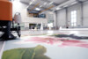close up of ink jet printing large size image set in a large warehouse room