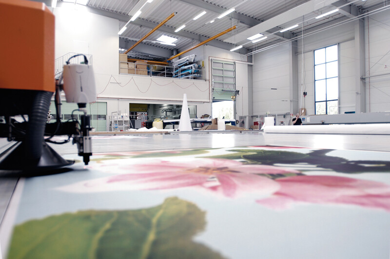 close up of ink jet printing large size image set in a large warehouse room