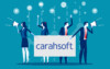 Two women and two men holding sign with Carahsoft on it