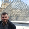 Person in front of the Louvre Pyramid