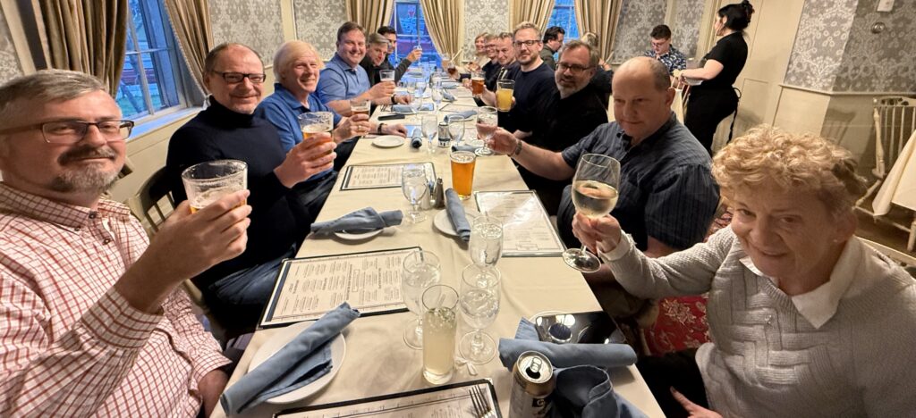 PDF Week attendees at the dinner table, raising their glasses.