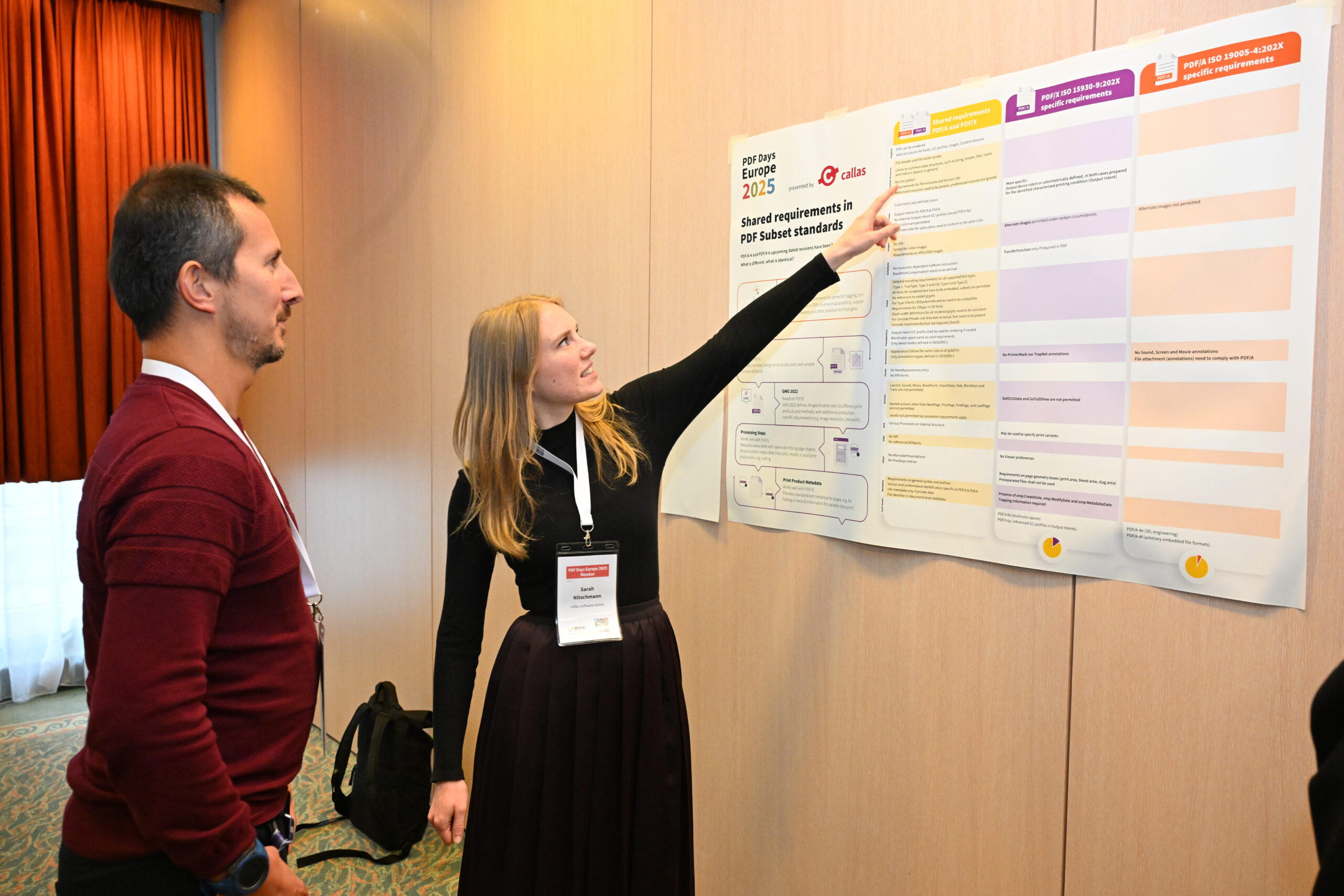 woman pointing at the Technical Poster Session winning poster by callas