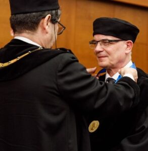 Frank Mittelbach in a black gown being awarded his honorary doctorate.