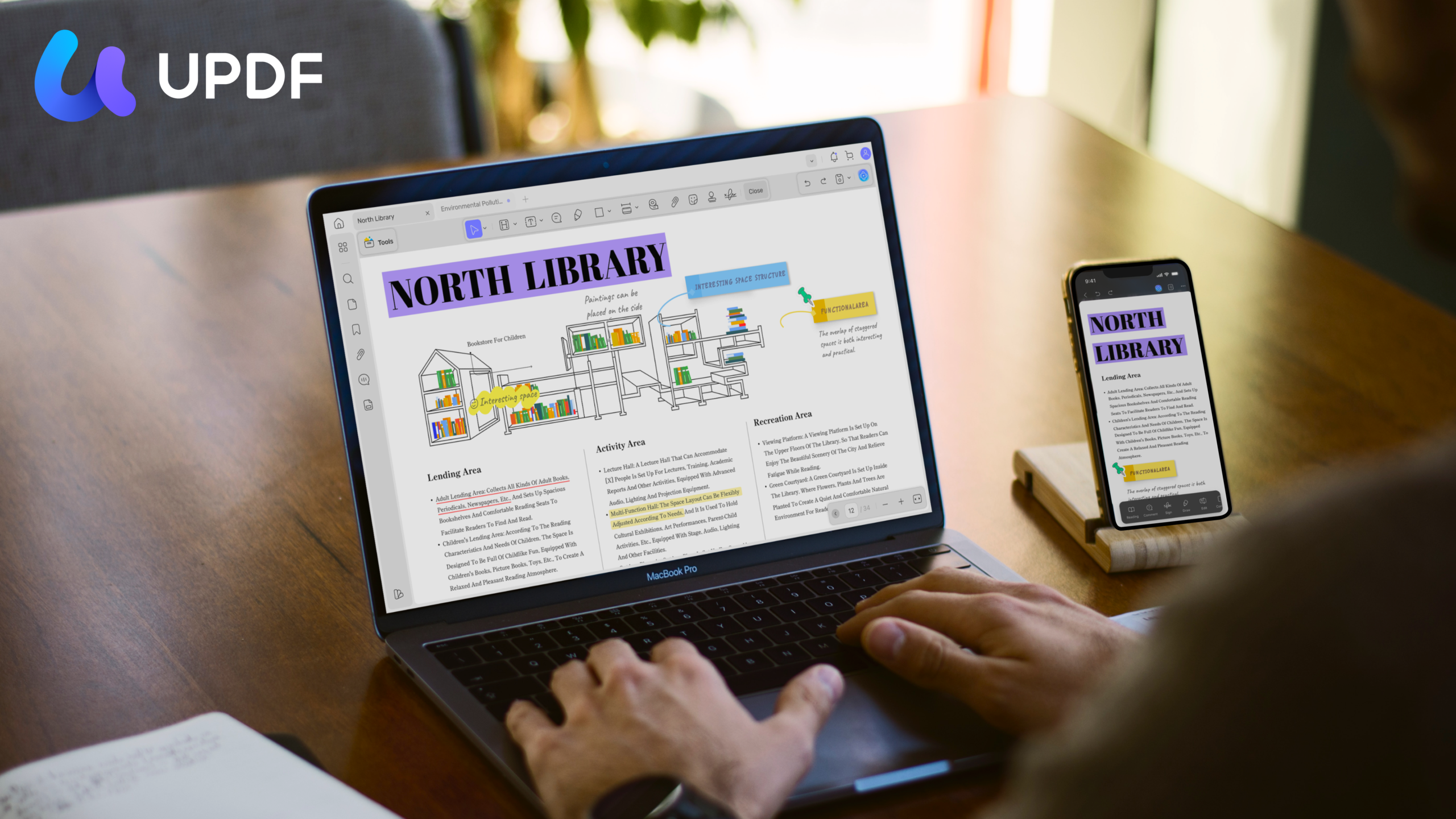 man with laptop and smartphone showing UPDF in action on screen