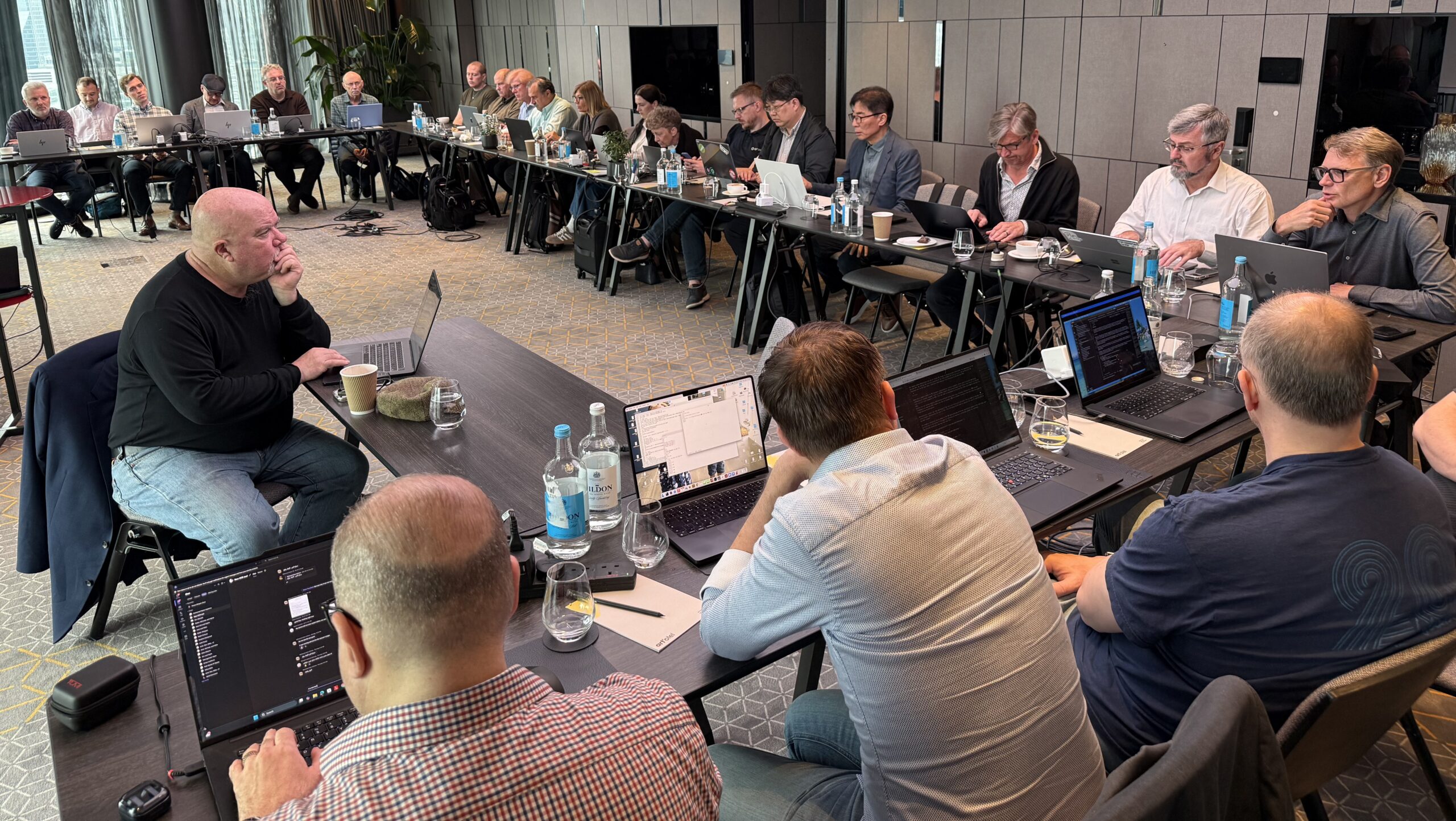 The meeting-room at PDF Days London 2026, with numerous attendees at the tables.
