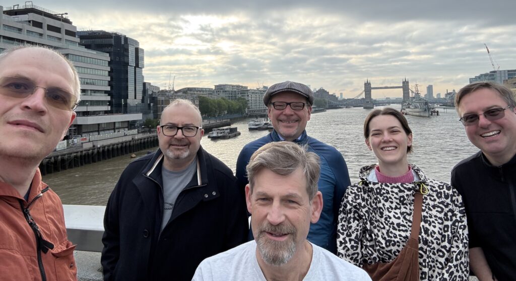 Roman Lasskiy, Ferass Elrayes, Markus Erle, Melina Tusch, Matthew Hardy and Duff Johnson on London Bridge facing Tower Bridge.