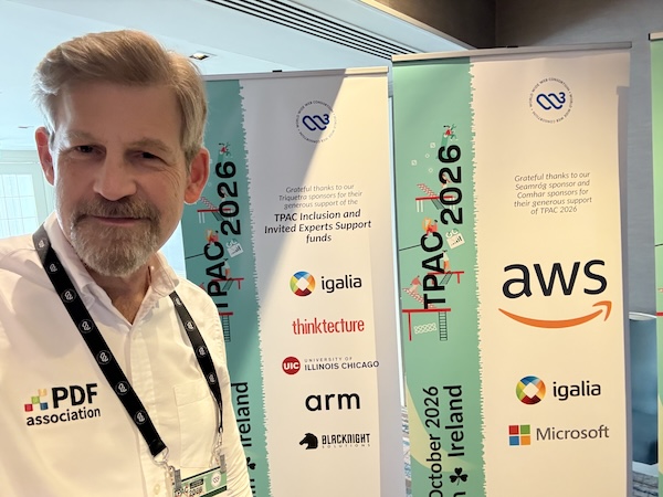Duff Johnson, wearing a PDF Association shirt, stands in front of W3C TPAC banners.